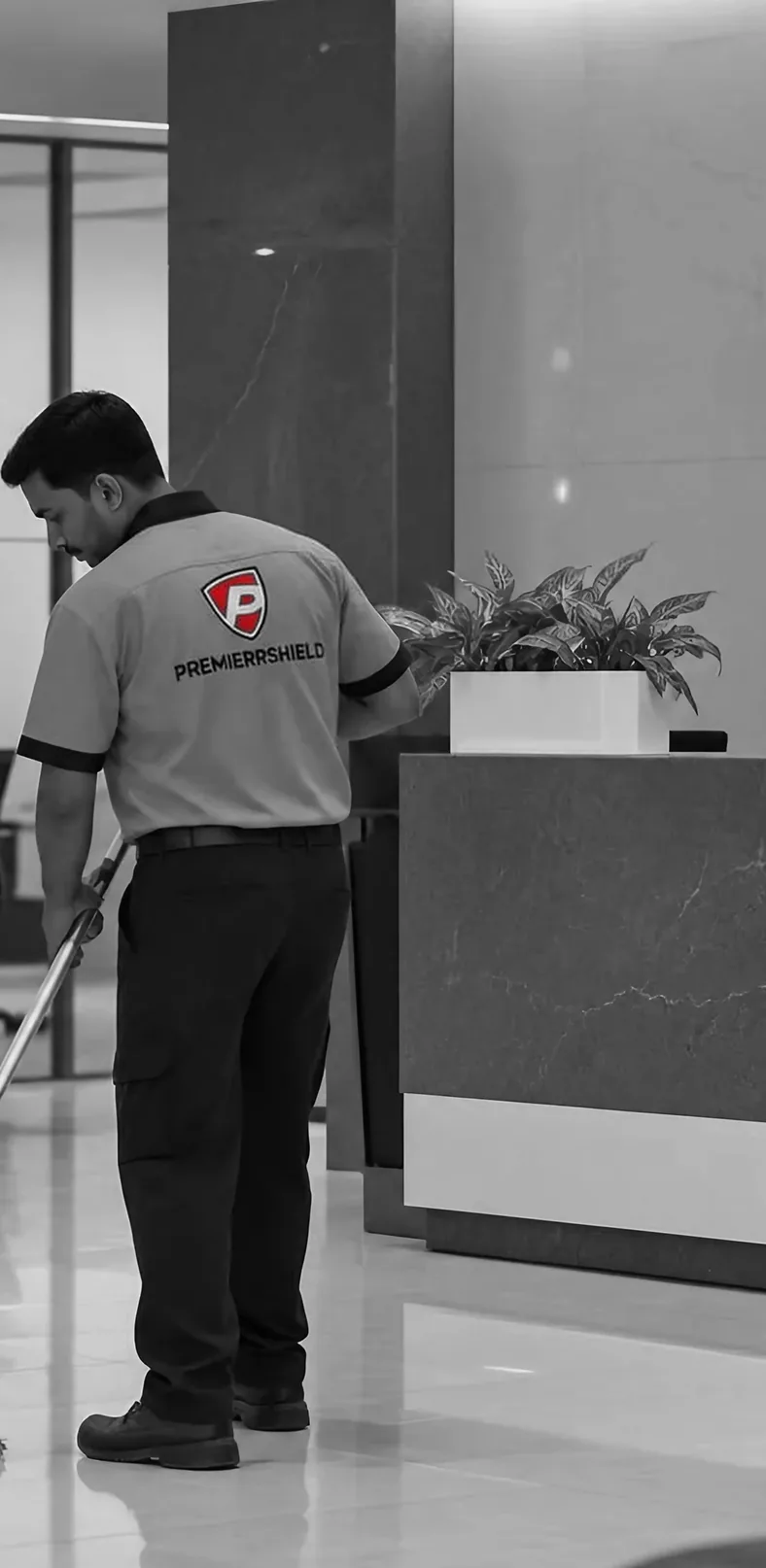 A facility services operative cleaning the floor of a reception area